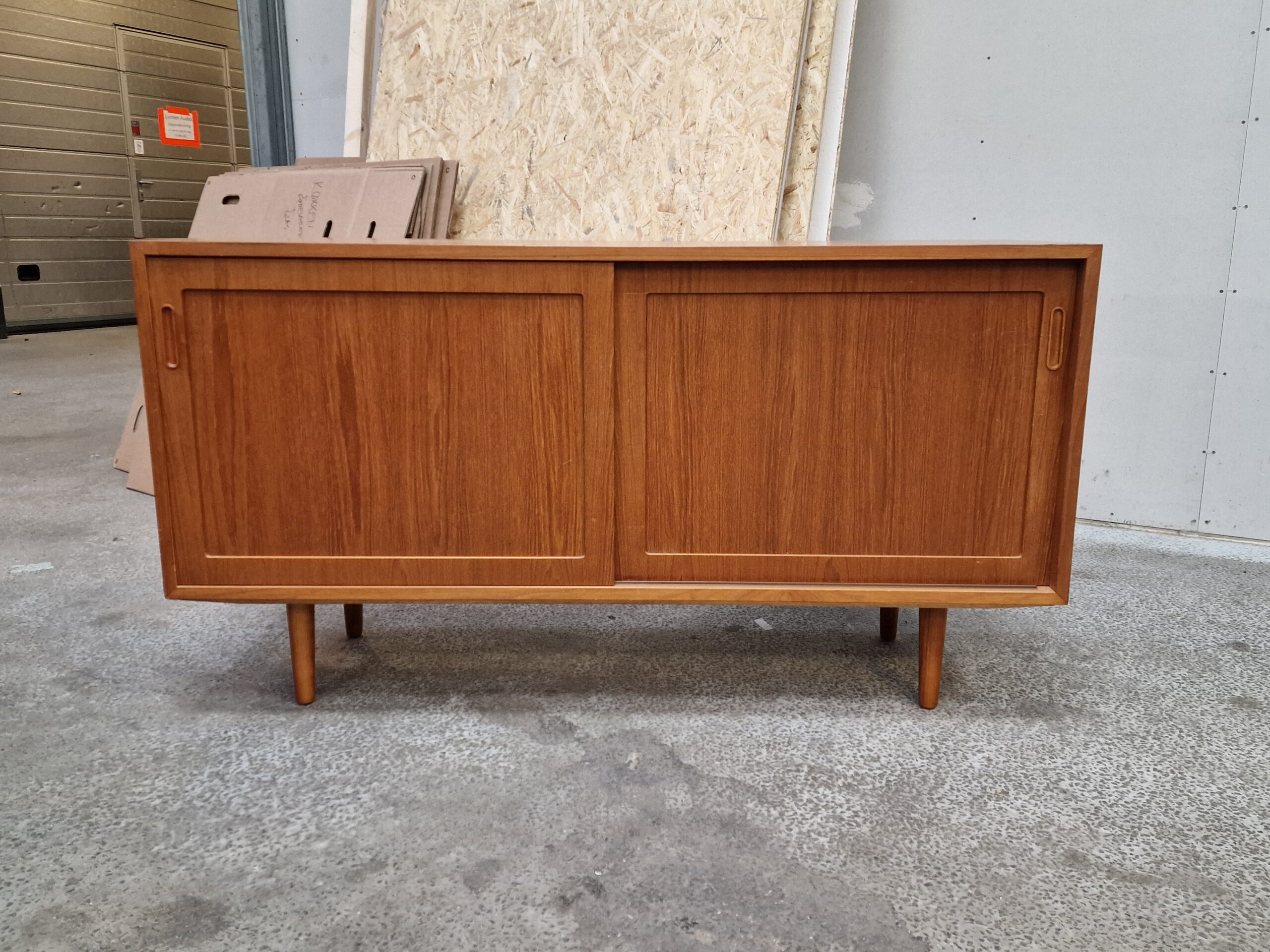 Mid-century modern teak sideboard with sliding doors.