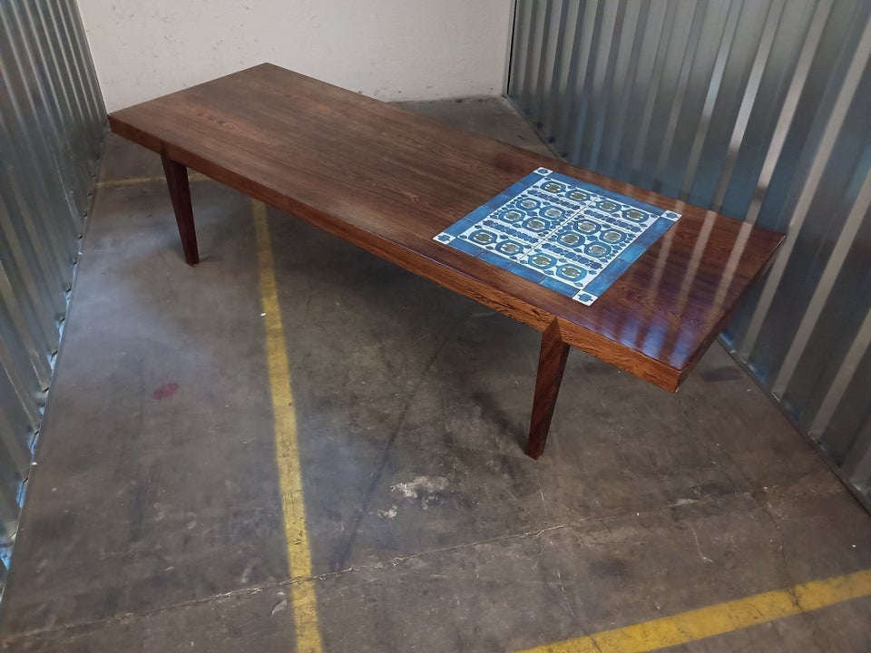 Mid-century modern coffee table with blue tile inlay.