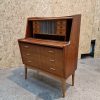 Mid-century vintage wooden cabinet featuring drawers, shelves, polished surface, tapered legs, and elegant craftsmanship.