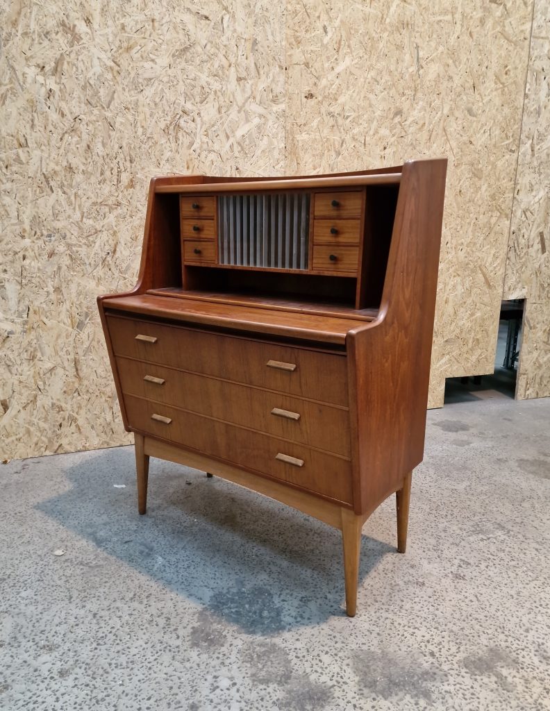 Mid-century vintage wooden cabinet featuring drawers, shelves, polished surface, tapered legs, and elegant craftsmanship.