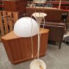 Mid-century modern cream table lamp with white shade.