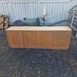 Mid-century modern wooden sideboard with sliding doors.