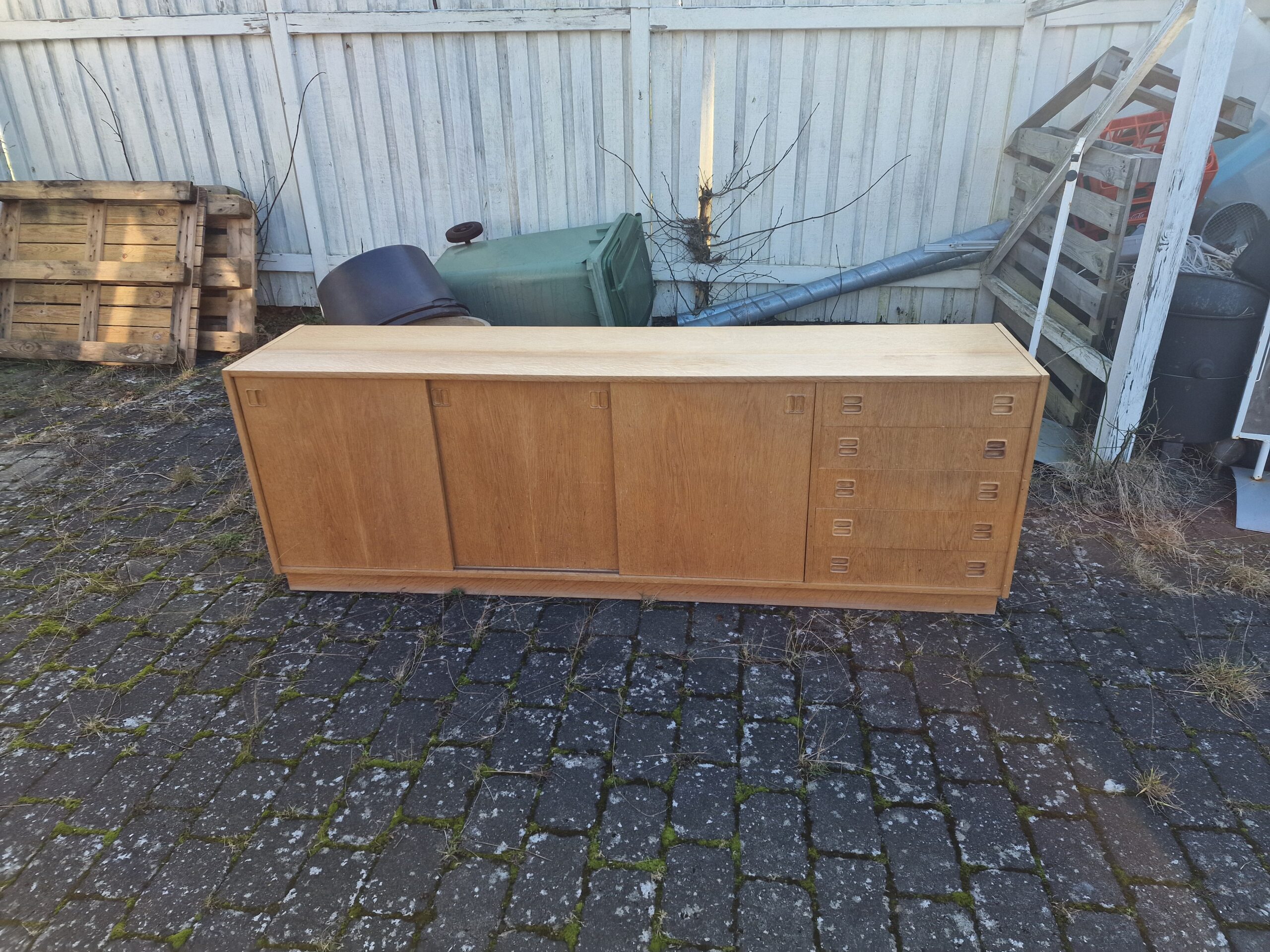 Mid-century modern wooden sideboard with sliding doors.