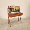Mid-century modern teak vanity with curved mirror and three drawers.