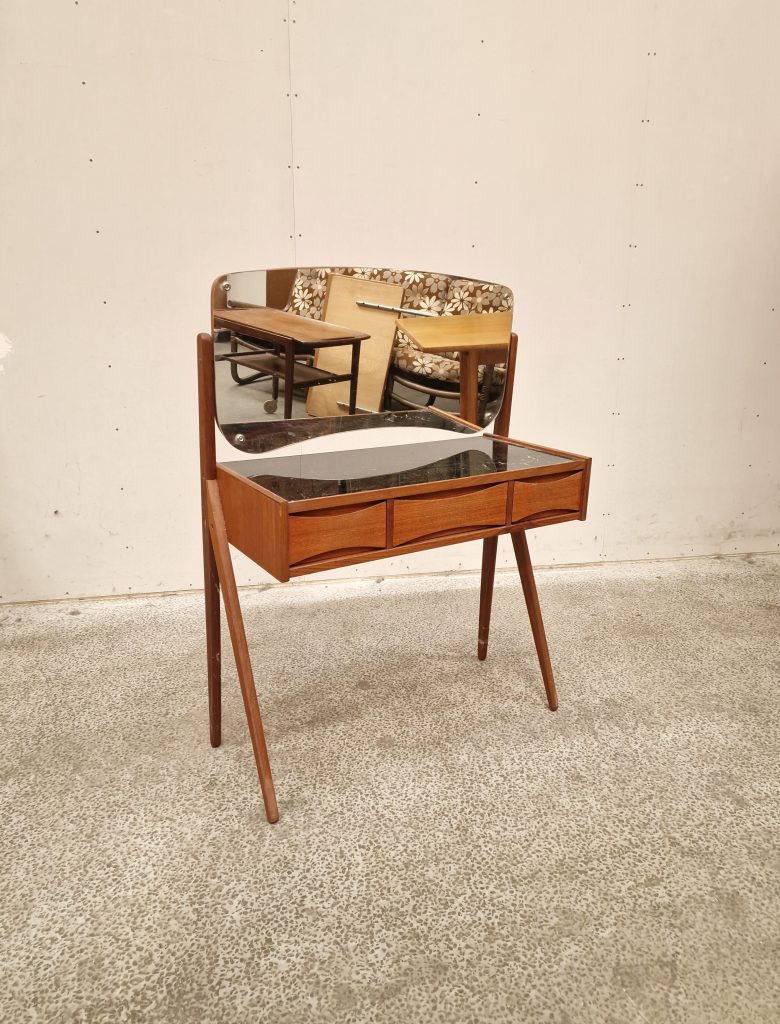 Mid-century modern teak vanity with curved mirror and three drawers.