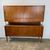 Mid-century modern teak sideboard with sliding doors and drawers.