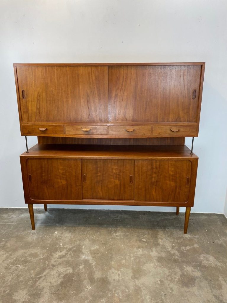 Mid-century modern teak sideboard with sliding doors and drawers.
