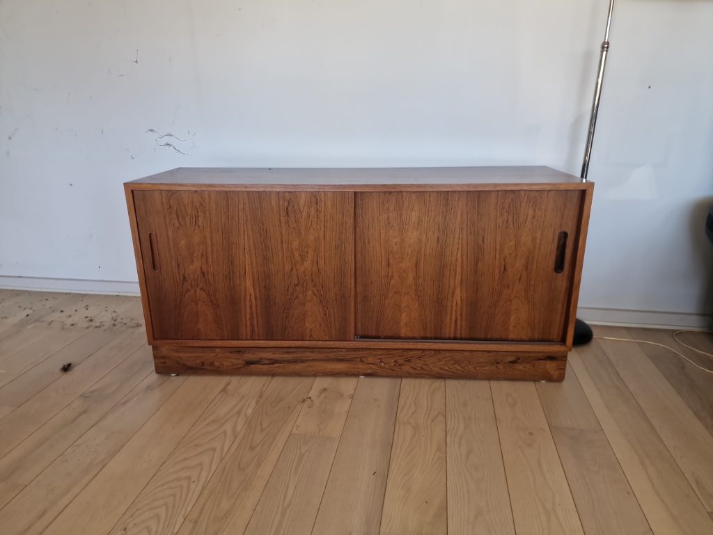 Mid-century modern sideboard: rosewood cabinet with sliding doors for stylish storage.