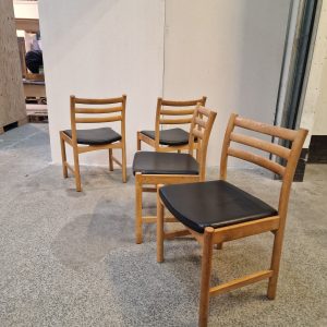 Fire spisestole i massiv egetræ og sort sæde