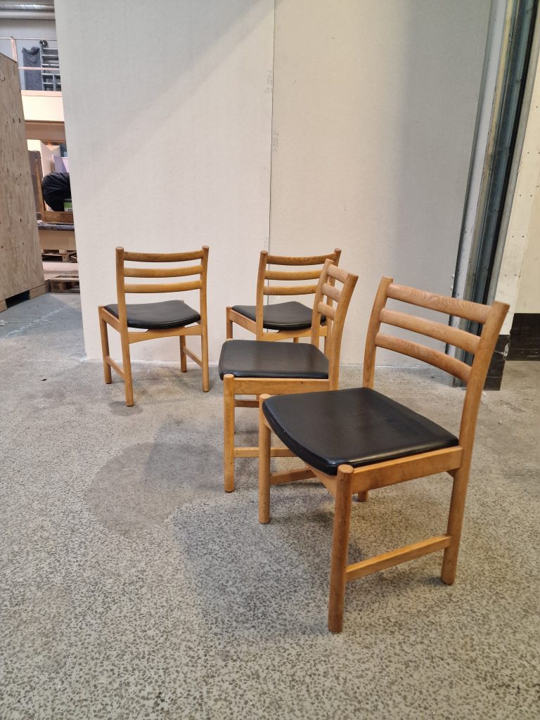 Fire spisestole i massiv egetræ med sort sæde